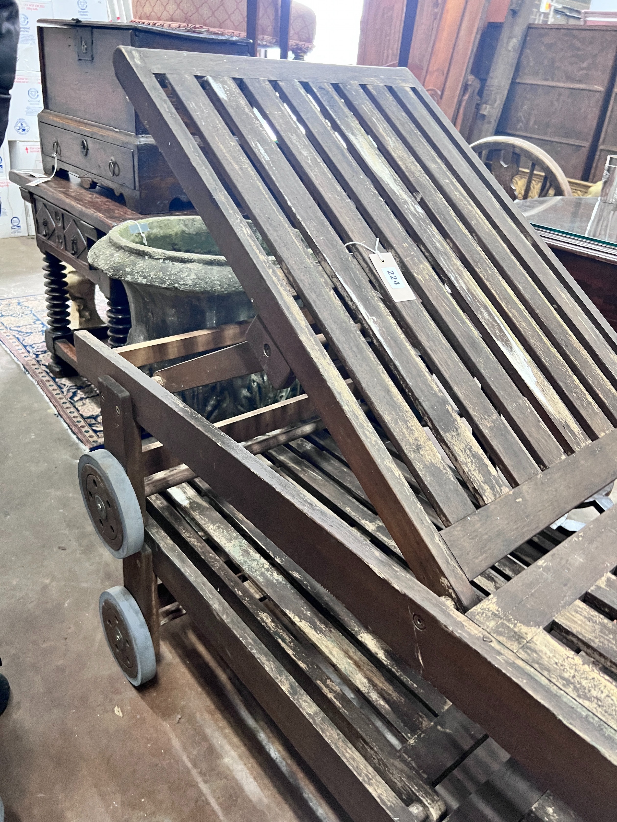 A pair of weathered teak steamer chairs, length 197cm *Please note the sale commences at 9am.